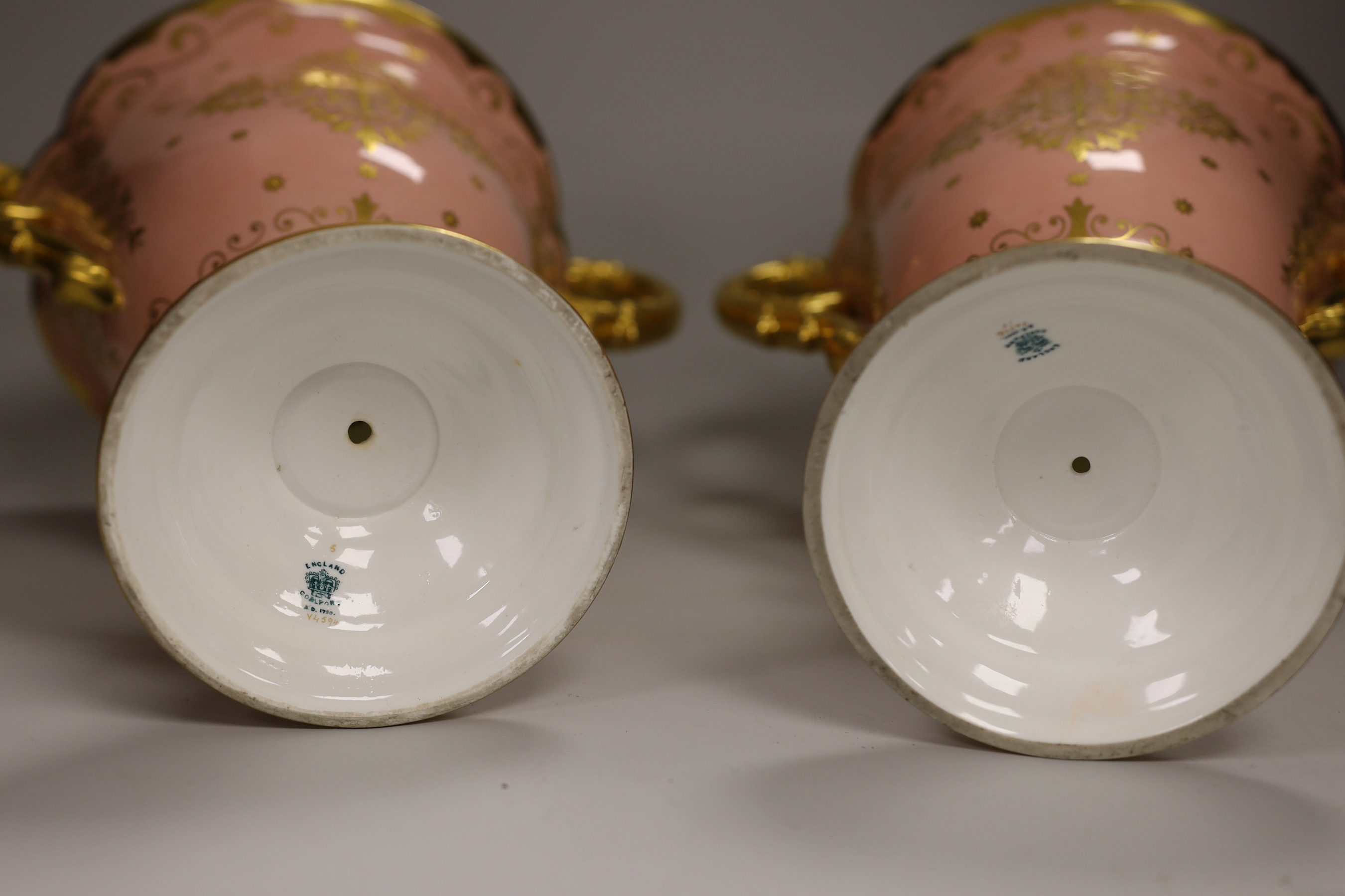 A pair of large Coalport salmon pink ground two handled loving cups, 28.5cm
